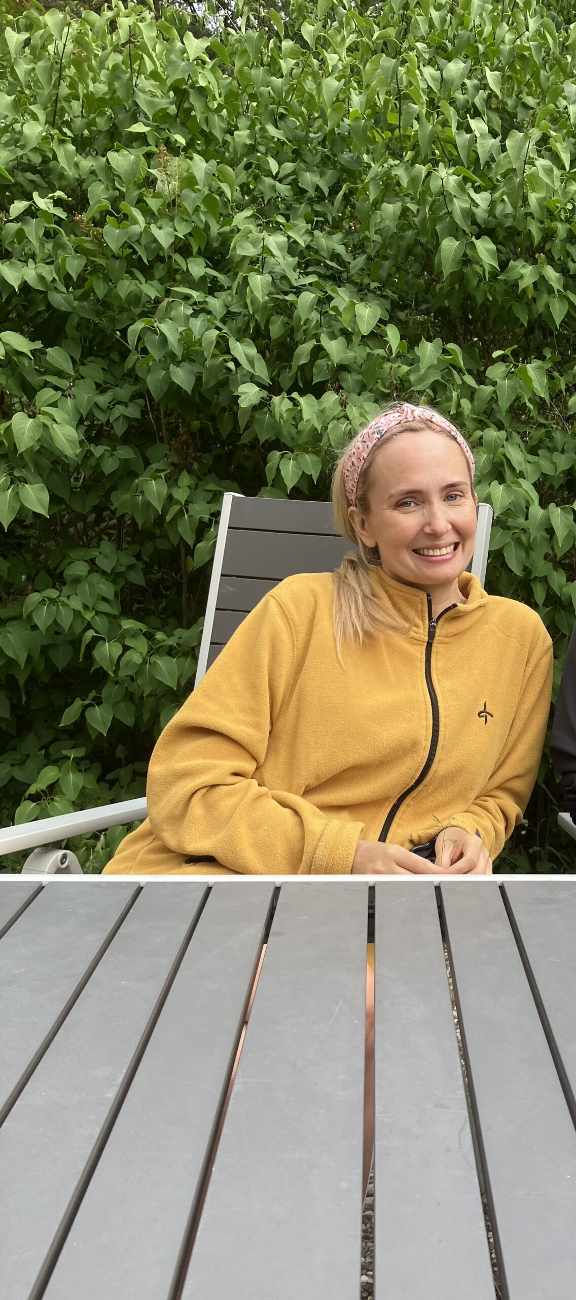 Maria-Katarina Johannesson smiling surrounded by green leaves